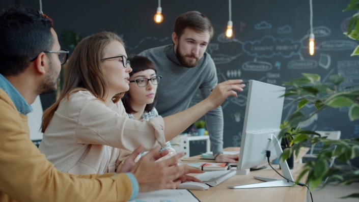 Team reviewing work together on a screen in a studio